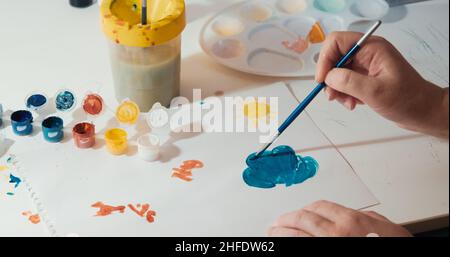 La donna invecchiata dipinge su carta. Il concetto di hobby, relax. Primo piano con le mani Foto Stock