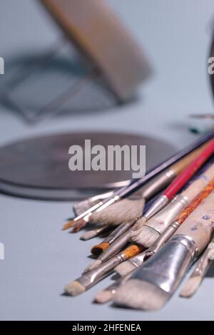 Strumenti di creatività - un mazzo di grungi pennelli del pittore su sfondo blu Foto Stock