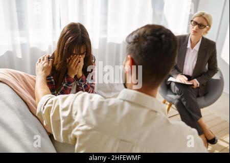 Coppia triste che sostiene il disaccordo all'ufficio degli psicologi Foto Stock