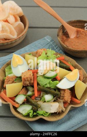 Insalata di verdure indonesiane Gado Gado con salsa di arachidi, primo piano sul tavolo. Foto Stock