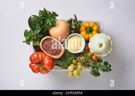 Assortimento di frutta fresca e verdure arcobaleno biologiche multicolore su fondo grigio in cemento. Cucina alimentare e sano fondo di cibo pulito e. Foto Stock