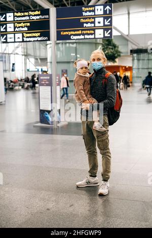 Famiglia in attesa vicino aeroporto cartello, arrivo e partenza zona. Uomo e ragazza felice pronta ad andare in aereo, padre va in vacanza con la figlia. Foto Stock