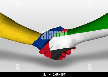 Handshake tra gli emirati arabi uniti e la columbia bandiere dipinte sulle mani, illustrazione con tracciato di clipping. Foto Stock