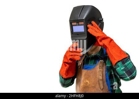 Saldatore in tuta protettiva, guanti, rimozione della maschera di saldatura, primo piano, luogo per il testo Foto Stock