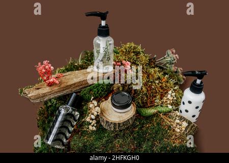 Bottiglie per cosmetici con crema e lozione. Cosmetici biologici naturali, medicina alternativa, essenza di erbe, concetto sostenibile. Colori neutri di groun Foto Stock