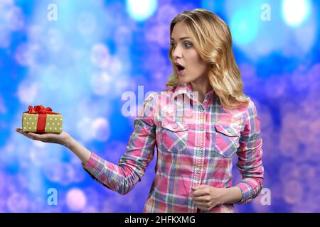 Giovane donna caucasica scioccata che gioisce del suo compleanno presente. Foto Stock