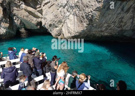 Capri, Italia - Ottobre 18 2021: Turista scatta una foto della famosa grotta verde con acque molto limpide lungo la suggestiva scogliera di Capri nella baia di Napoli i. Foto Stock