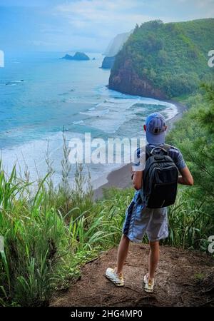 Un escursionista che si affaccia Pololu Valley sulla Big Island delle Hawaii Foto Stock