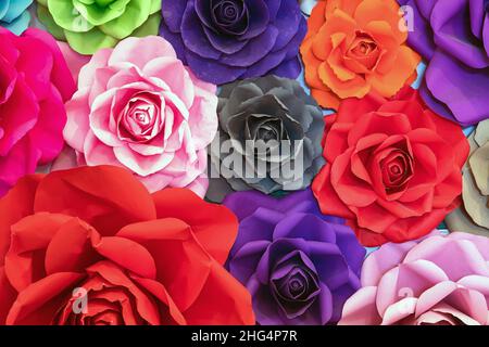 Rosa fatta di carta. Rose fatte a mano sfondo. Collezione di molte rose colorate origami che formano un bellissimo sfondo floreale. Col artificiale Foto Stock