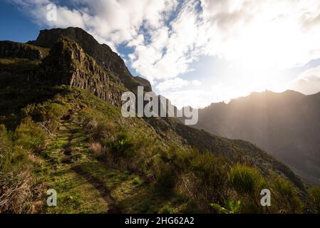 Bellissimo paesaggio montagnoso all'alba, che mostra un tratto di sentiero del sentiero escursionistico "Vereda da Encumeada", che porta verso Pico Ferreiro, Madeira Foto Stock