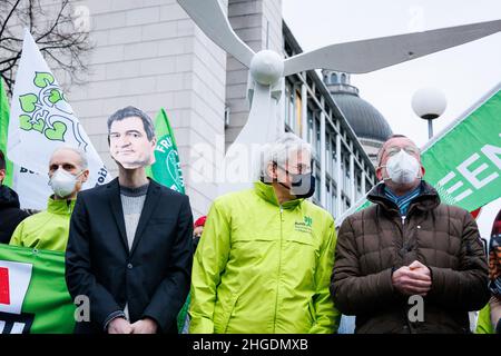 Presidente di Bund Naturschutz, Richard Mergner si trova accanto ad un attivista ambientale che indossa una fessura di cartone con il volto di Markus Soeder. Il 20 gennaio 2022 il leader del partito Verde Buendnis 90/Die GRUENEN, Vice Cancelliere e Ministro dell'economia e della protezione del clima Robert Habeck ha visitato il Presidente del Ministro bavarese nella Cancelleria di Stato bavarese a Monaco di Baviera, in Germania. Di fronte ad essa, gli attivisti ambientali hanno protestato per l’energia eolica e contro la regola del 10H. La regola del 10H dice che la distanza tra una turbina eolica e le case deve essere 10 volte l'altezza. (Foto di Ale Foto Stock