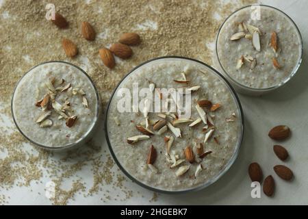 Porridge di miglio di Barnyard. Un porridge facile e sano per la colazione con miglio da cortile, latte e mandorle. Girato su sfondo bianco con il barnyard mi Foto Stock