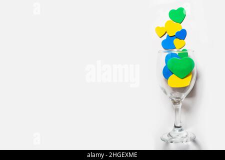 Gli sfondi di San Valentino. Cuori multicolore in un bicchiere, isolati in bianco Foto Stock