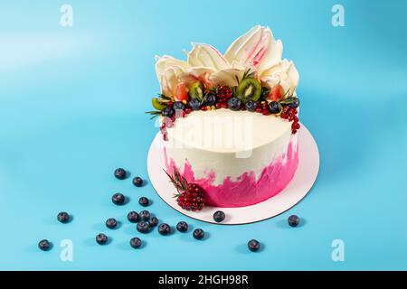 Torta con la guarnizione originale e bella su sfondo blu, primo piano con spazio copia. Foto Stock