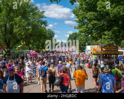 FALCON HEIGHTS, MN - 22 AGO 2019: Minnesota state Fair folla godersi una giornata di sole su una strada alberata. Foto Stock
