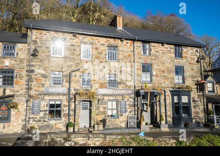 Prince Llewelyn,pub,hotel,case,di,proprietà,edifici,in,Beddgelert,an,attraente,villaggio,nella,Snowdonia, area, di, Gwynedd, Galles. La popolazione della comunità presa al censimento del 2011 era di 455 abitanti. Beddgelert si trova 13 miglia a nord di Porthmadog in una valle isolata alla confluenza di due fiumi, l'Afon Glaslyn e l'Afon Colwyn. Sopra l'incrocio dei fiumi, nel centro del villaggio, si trova il vecchio ponte in pietra a due archi.Rural, campagna, scenico, scenario, in,on,at,Snowdonia,Snowdonia National Park,Mid,North,West,Kingdom,North Wales,Wales,Welsh,GB,Great Britain,British,UK,United Foto Stock