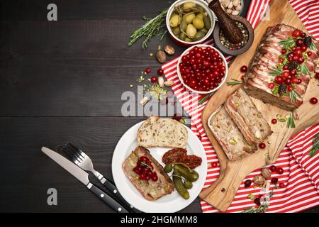 Terrina francese tradizionale coperta con pancetta su sfondo di legno scuro con decorazioni natalizie Foto Stock