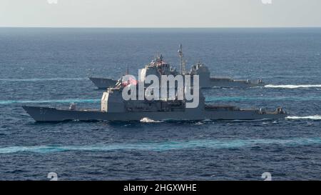 220122-N-PQ495-1044 PHILIPPINE SEA (Jan. 22, 2022) Ticonderoga-class guided-missile cruiser USS Lake Champlain (CG 57), front, and Ticonderoga-class guided-missile cruiser USS Mobile Bay (CG 53), transit the Philippine Sea Jan. 22, 2022. Operating as part of U.S. Pacific Fleet, units assigned to Carl Vinson and Abraham Lincoln Carrier Strike Groups, Essex and America Amphibious Ready Groups and Japan Maritime Self-Defense Force, are conducting training to preserve and protect a free and open Indo-Pacific region. (U.S. Navy photo by Mass Communication Specialist Seaman Larissa T. Dougherty) Stock Photo