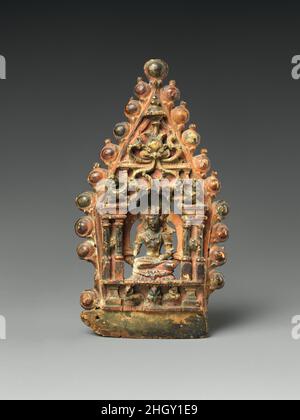 Panel of a Buddhist Ritual Crown with Ratnasambhava, the Transcendent Buddha of the South 10th–11th century India (Jammu and Kashmir) or western Tibet Ratnasambhava is one of the five Transcendent Buddhas of Esoteric Buddhism. Horses are his traditional mounts.. Panel of a Buddhist Ritual Crown with Ratnasambhava, the Transcendent Buddha of the South. India (Jammu and Kashmir) or western Tibet. 10th–11th century. Wood with traces of polychrome. Sculpture Stock Photo