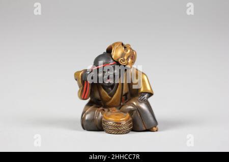 Netsuke di ragazzo con una maschera 19th secolo Giappone. Netsuke di ragazzo con una maschera 59060 Foto Stock