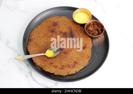 Roti dolci a base di farina di riso, gelate e ghee. gur ki roti. gur ki roti, bhakri gelatinoso, roti meethi gud ki cotto in foglia di banana. Cibo invernale Foto Stock