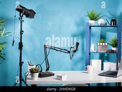 Lampada video professionale in studio di trasmissione vlog vuoto con microfono utilizzato per la registrazione di contenuti di social media. Configurazione del vlogging con la console del mixer digitale e il computer portatile. Foto Stock