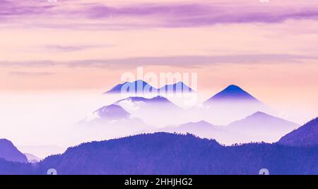 Immagine tranquilla di un paesaggio tranquillo con montagne blu e cielo pallido. Foto di alta qualità Foto Stock