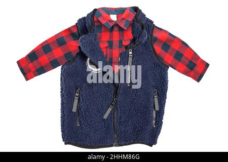 Gilet in pelliccia. Un gilet in pelliccia blu con fodera in lana blu e una camicia a scacchi rossa per il ragazzino isolato su sfondo bianco. Molla per bambini e a. Foto Stock