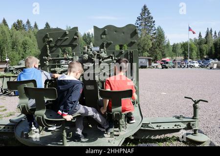 Ragazzi che giocano con la pistola automatica antiaerea S-60 a Gora Filina, Karelia Foto Stock