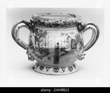 POT. Posset ca. 1687 i coloni delle fabbriche di Lambeth usavano vasetti per bere spouted per il consumo di posset e di altre bevande. Per fare l'insieme, varie combinazioni di uova, panna, zucchero, pane, vino e birra sono stati bolliti, scremato, e servito caldo. Il beccuccio ribassato era utile per i liquidi che avevano la schiuma che galleggiava sulla parte superiore. Questo posset pot è decorato in un motivo chinoiserie che imita porcellana cinese disegni.. POT. Posset. Inglese. CA. 1687. Terracotta stagnata. Fabbricato a Londra, Inghilterra Foto Stock