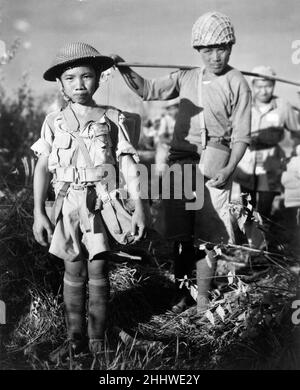 Ritratto di un bambino soldato cinese di 10yr anni, un membro di una divisione militare a bordo di un aereo che li riporta in Cina, dopo la cattura del campo aereo di Myitkyina, Birmania, sotto il comando del generale maggiore americano Frank Merrill, maggio 1944. Foto Stock