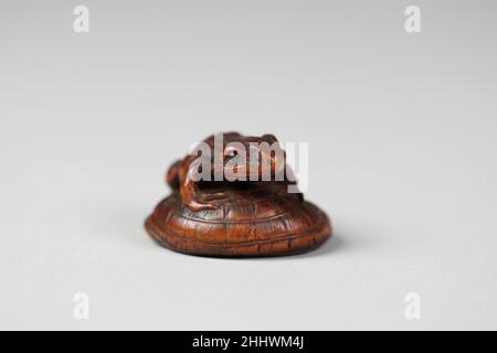 Netsuke di rana su un cappello di paglia 18th secolo Giappone. Netsuke di rana su un cappello di paglia 59709 Foto Stock