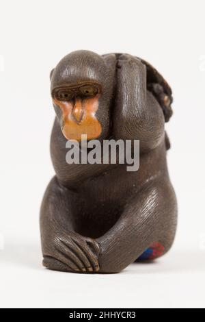 Netsuke di scimmia seduto che porta un mazzo di uve e foglie 19th secolo Koichi giapponese. Netsuke di scimmia seduto che porta un mazzo di uve e foglie 59630 Foto Stock