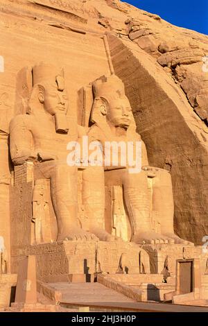 Colossi di Rameses II e Nefertari nella facciata del Grande Tempio di Ramesses II, Abu Simbel, Egitto Foto Stock