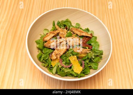 Insalata vegana mediterranea. Sei in 'verde'? Mix di lattuga e canoni, Heüra, mais, pomodoro ciliegia, peperoni arrostiti e olive verdi Foto Stock