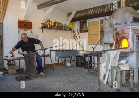 Murano, Italia - 2 novembre 2012: Un maestro vetraio al lavoro nella sua officina. Murano è una serie di isole collegate da ponti nella laguna veneta Foto Stock