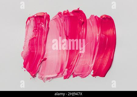 Pennellate rosa su sfondo bianco. Foto Stock