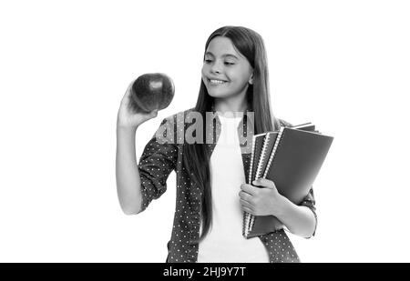 felice bambino tenere copybook scuola per lo studio e pranzo mela isolato su bianco, di nuovo a scuola Foto Stock