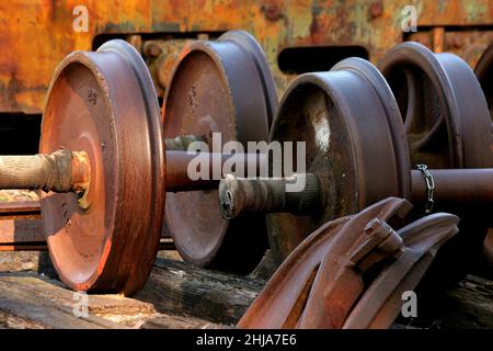 Grandi parti industriali in metallo arrugginito pesante con parete arrugginita Foto Stock