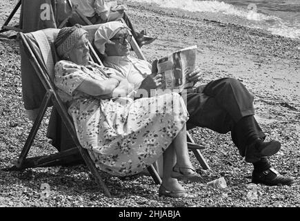 I viaggiatori anziani che si trovano nell'East End di Londra, si rilassano al sole estivo sulla spiaggia di Southend, Essex. 24th luglio 1963 1704 Foto Stock