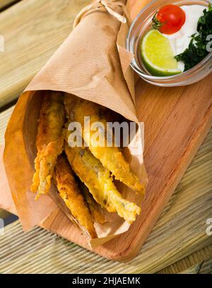 Fritto in acciughe pastella con salsa cremosa al formaggio e verdure Foto Stock