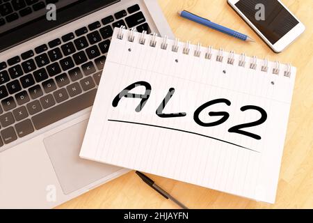 alg2 - Arbeitslosengeld - parola tedesca per l'indennità di disoccupazione o dole money - testo scritto a mano in un taccuino su una scrivania - 3D rappresentazione illustrazione. Foto Stock