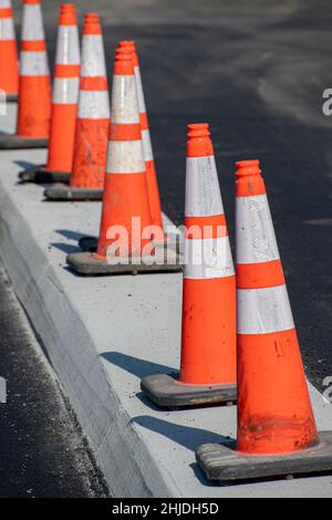 Colpo verticale di coni di traffico arancioni in un cantiere. Foto Stock