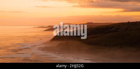 Morgan Bay Cliffs sulla Wild Coast in un nebbiosa tramonto Dusky Foto Stock