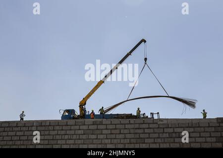 Nairobi, Kenya. 26th Jan 2022. Una visione generale dei lavoratori edili che lavorano su una sezione di un cantiere del progetto Nairobi Expressway lungo la strada Mombasa. La costruzione dell'autostrada a pedaggio lunga 27,1km, la Nairobi Expressway continua e si prevede che sarà completata nel giugno 2022. La superstrada di Nairobi è destinata a decongest la città di Nairobi fornendo trasporti più veloci e affidabili. Credit: SOPA Images Limited/Alamy Live News Foto Stock