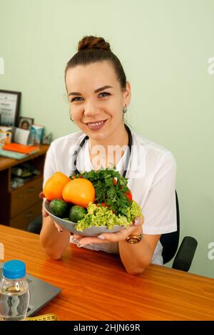 Nutrizionista che dà la consultazione al paziente con vegetale sano. Foto Stock