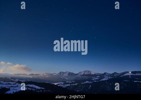 Freddo paesaggio invernale in luce notturna nelle Alpi di Allgaeu vicino Oberstaufen, Baviera, Germania Foto Stock