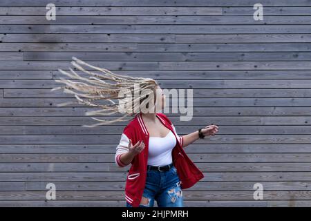 donna bionda con dreadlocks che si aggira i capelli Foto Stock