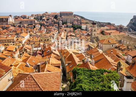 Vista dei tetti colorati tradizionali e della Chiesa Francescana e del Campanile del Monastero con il Mare Adriatico sullo sfondo Foto Stock