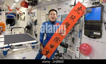 (220131) -- PECHINO, 31 gennaio 2022 (Xinhua) -- Taikonaut Zhai Zhigang, comandante della missione Shenzhen-13, dice "auguro a tutti voi buona salute e buona fortuna in tutto ciò che fate", mentre si visualizza un paio di coppie, in uno screenshot ottenuto da un video. I membri dell'equipaggio di Shenzhen-13 sono diventati i primi cinesi a trascorrere il festival più importante della nazione -- il Capodanno lunare cinese -- nello spazio esterno. Credit: Xinhua/Alamy Live News Foto Stock